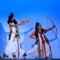Two dancers portraying Agasthya and Rama with blue background
