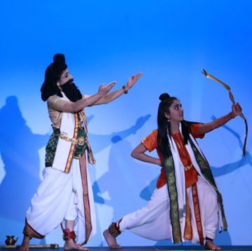 Two dancers portraying Agasthya and Rama with blue background