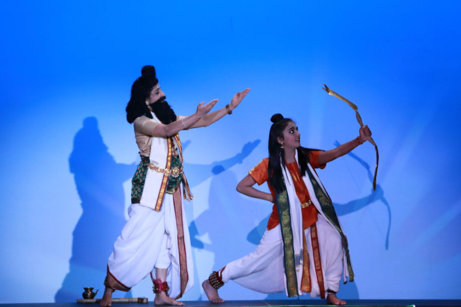 Two dancers portraying Agasthya and Rama with blue background